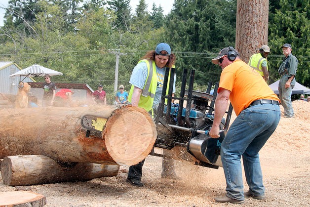 Participants compete in the annual logging contests -- speed cutting in the photo above and log rolling  below -- at the Island County Fair last week.