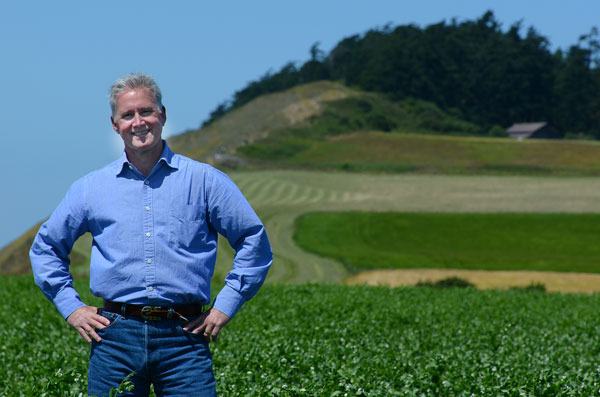 Reserve Manager Mark Preiss poses for a picture with Ebey’s Bluff in the background. Preiss