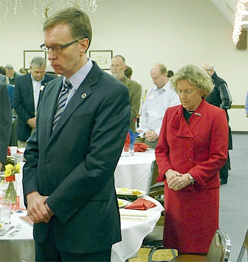 Washington state Attorney General Rob McKenna and State Representative Barbara Bailey pray during an invocation at a kickoff breakfast Tuesday morning at the Oak Harbor Elks Lodge. Bailey is running for State Senate.