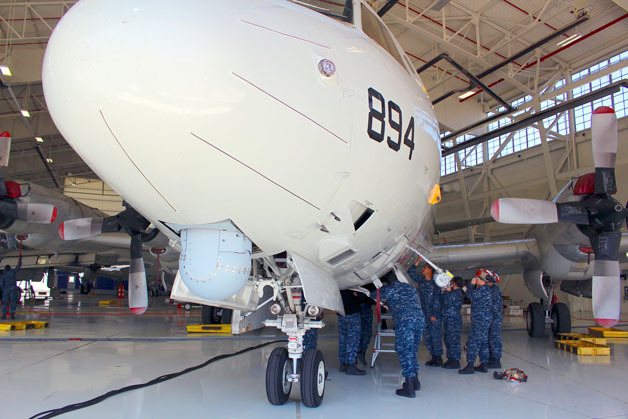 Naval Air Station Whidbey Island sailors work on a P-3C Orion last week in hangar 9. Workers are busy renovating hangar 6 to accommodate the new P-8A Poseidon