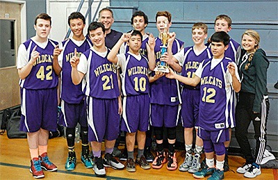 The Oak Harbor eighth-grade AAU basketball team shows off its championship trophy after winning the SWISH title.