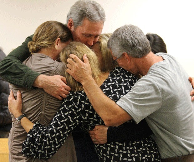 Kathie Baker's family members hug after Robert 'Al' Baker is sentenced to 52 years in prison for murdering her.