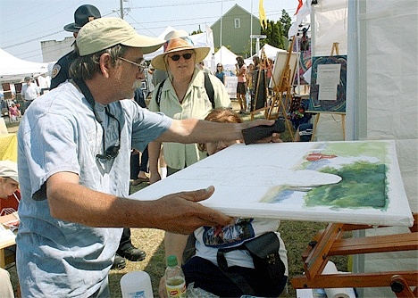 Coupeville resident Peter Durand takes a look at the canvas used by watercolorist Michele Kempees-Lewis at the “Artists in Action” booths. Fourteen artists demonstrated their craft