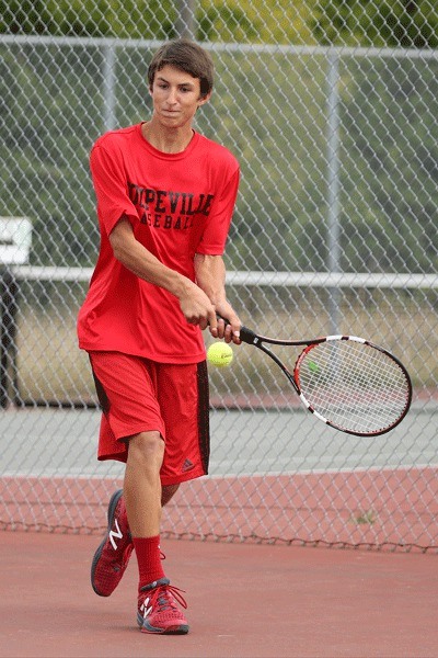 Joey Lippo uses a backhand shot to win the second doubles match with partner William Nelson.