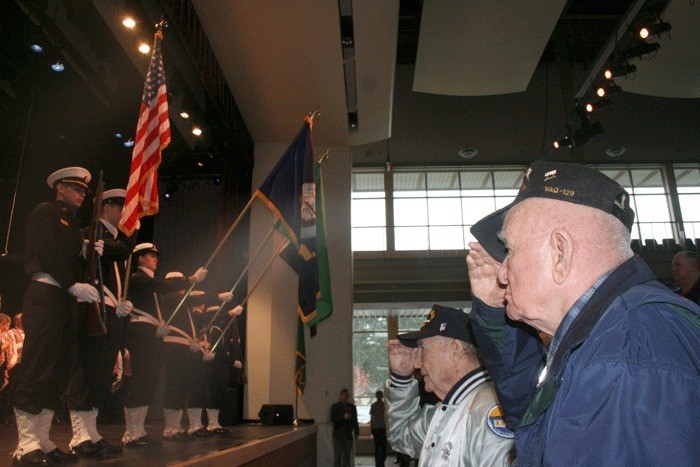 Veterans Anthony Nady and James Stansell salute the flag. They were honored at a Veterans Day ceremony for their service during the attack on Pearl Harbor.