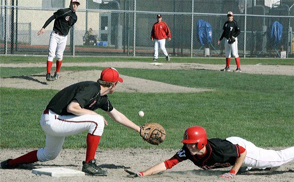 Coupeville’s J.D. Wilcox’s pickoff throw to Kevin Eaton arrives a moment late in the Wolves’ tri-district game.