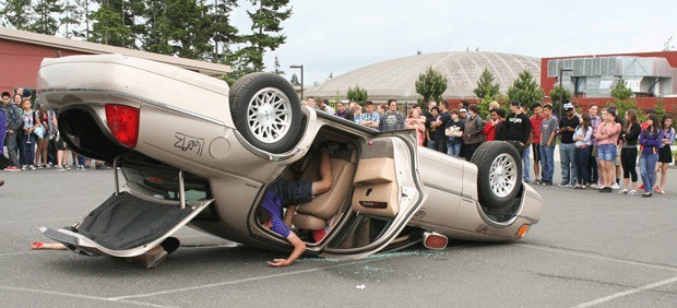 An Oak Harbor High School student pretends to be injured during a drunk driving vehicle accident simulation sponsored by Students Against Drunk Driving.