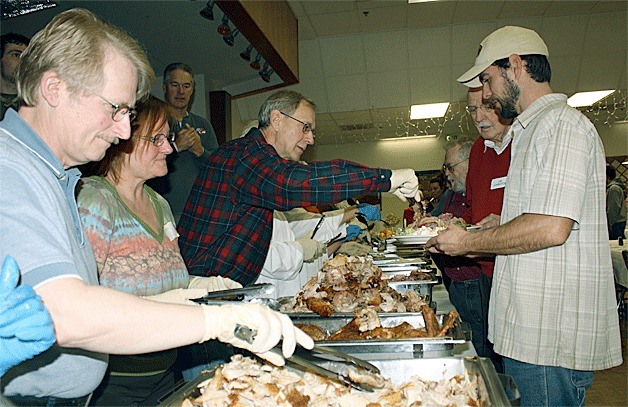 Volunteers from the 2011 Community Harvest in Oak Harbor served thousands of people who ventured to the Elks Lodge for a feast an fellowship on Thanksgiving.