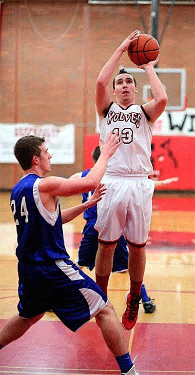 Aaron Trumbull puts up a jumper over Chimacum's Brandon Naylor in Wednesday's game.