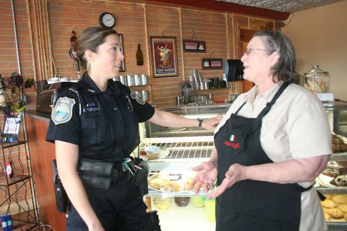 Oak Harbor Police Officer Jennifer Yzaguirre stops by Angelo’s Caffe to talk to Kathy Collantes about downtown law enforcement issues. Yzaguirre is the department’s first community service officer in the new Community Service Team.