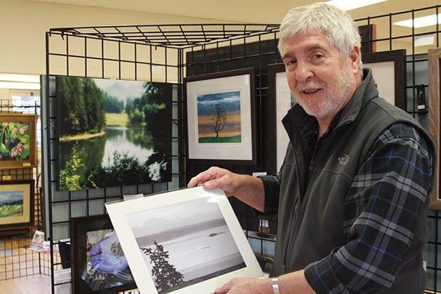 Bruce Williams-Burden stands before an exhibit of his photography put on by the Whidbey Allied Artists in Coupeville in October.  After serving as a Navy Hospital Corpsman in Vietnam and 40 years as a physician’s assistant