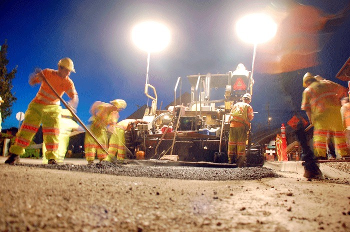 Laborers from Anacortes-based Lakeside Industries smooth out fresh asphalt on Dock Street in downtown Oak Harbor Monday night.