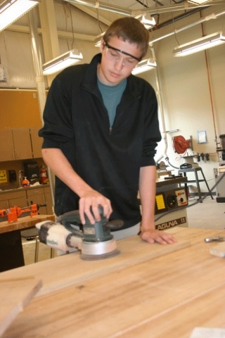 Coupeville High School sophomore Nevin Miranda sands wood he will use to construct a bookcase during a Woodlinks class