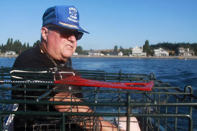 Dave Anderson of Coupeville takes a boat out to set crab pots in Holmes Harbor Thursday