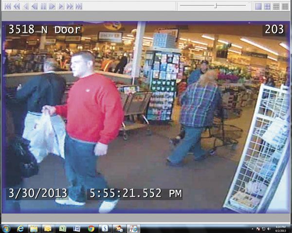 An image from a security camera at Safeway shows a person of interest in an assault case. The victim said the man in red grabbed her in the back room.