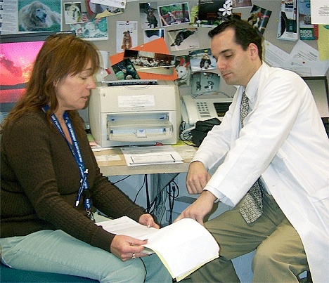 Social worker Serena Newbauer consults with Dr. Zachary Phelps.