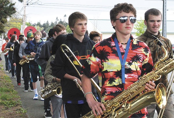 Baritone saxophonist Andrew Eaton and the rest of the eighth grade marching band from Oak Harbor Middle School head to the Der Kinderhuis Montessori Thursday to surprise the preschool students for the second year in a row.