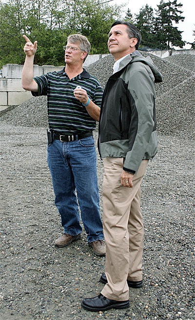 Chuck Krieg of Krieg Concrete gives Republican Senate candidate Dino Rossi a tour of his facility on Thursday in Oak Harbor.