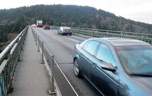 Cars drive over Deception Pass Bridge