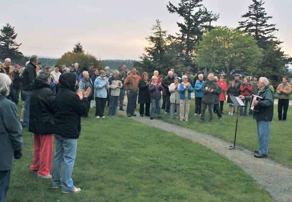 Vern Olsen plays a hymn for worshipers at an Easter sunrise service at Sunnyside Cemetery in Coupeville. Olsen