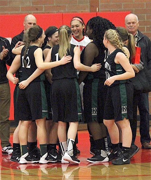 The Klahowya team congratulates Coupeville's Makana Stone (white uniform) before Saturday's game.