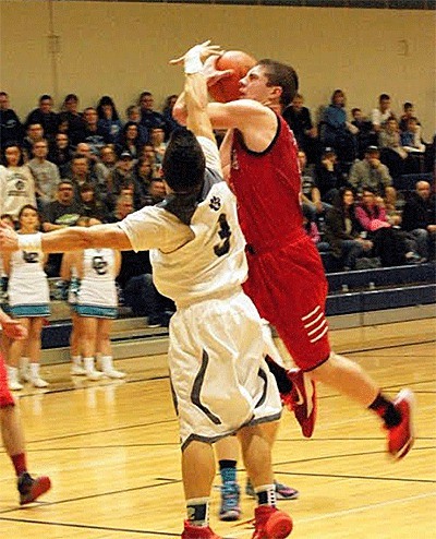 Coupeville's Wiley Hesselgrave battles through the Cascade Christian defense on the way to the hoop.