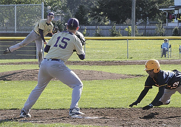 Oak Harbor pitcher Teddy Peterschmidt throws to first baseman Rhys Mattila in an attempt to pick off Everett's Michael Larson.