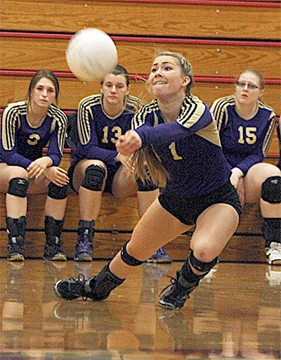 Natalie McVey lunges for a dig in Oak Harbor district match Saturday as Hailey Beecher (3)