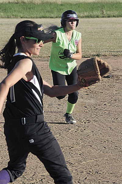 Central Whidbey's Hope Lodell races to third as Trinity Olvera awaits the throw.