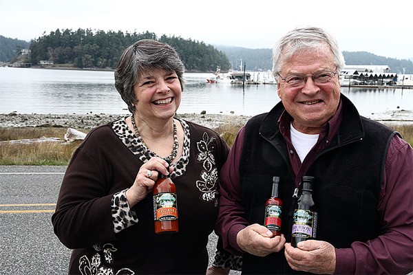 Joanne and Arnie Deckwa show off some of their products outside their company’s headquarters on Cornet Bay.