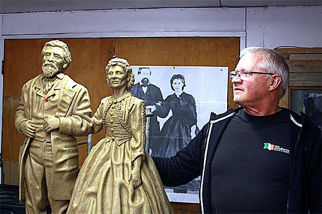 North Whidbey artist Wayne Lewis stands before a clay sculpture of one of Oak Harbor’s prominent early pioneers