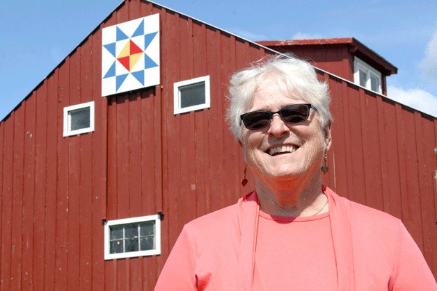 Joyce Kuhn is pleased with her first attempt at creating a barn quilt on her North Whidbey barn. The 8-foot-by-8-foot square is made of plywood. Kuhn said a barn quilt trail would suit Whidbey Island. Another square is featured at Hummingbird Farm Nursery and Gardens