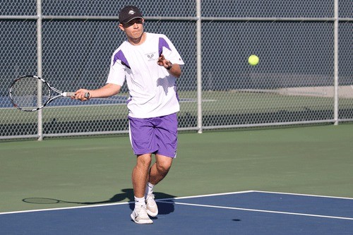 JJ Mitchell returns a shot in his first singles win Wednesday.