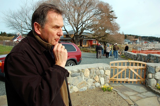 Greenbank property owner Bruce Montgomery speaks to a reporter during a community demonstration on Wonn Road in early 2009. Island County is suing Montgomery for a wall he built on property that may be a public beach access.