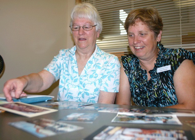 Carol Dyer and Leslie Franzen look through old photos as they prepare for the Coupeville Library’s 50th anniversary bash. Dyer managed the library from 1968 to 1998 and Franzen is the current branch manager. Carol Dyer and Leslie Franzen look through old photos as they prepare for the Coupeville Library’s 50th anniversary bash. Dyer managed the library from 1968 to 1998 and Franzen is the current branch manager.