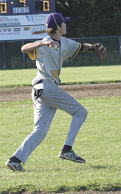 Oak Harbor third baseman Preston Rankin scoops up a slow roller and throws out a Burlington batter.