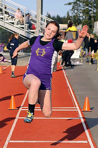 Claire Anderson leaps to second place in the triple jump Friday.