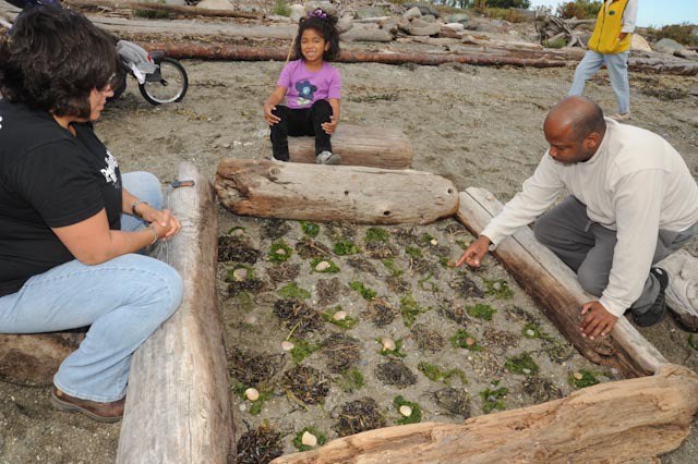 A family works on their sculpture at a previous Driftwood Day. The fifth annual event begins this Saturday at 11:30 a.m. at Windjammer Beach Park in Oak Harbor.