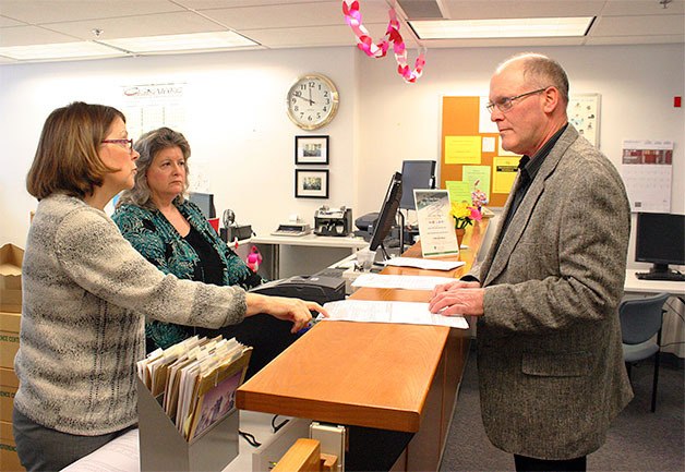 County Treasurer Wanda Grone looks on as Janice Wilson