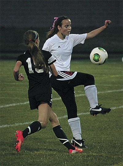 Ana Luvera works to gain possession in Tuesday's match. South Whidbey's Zoe Tapert (15) closes in.