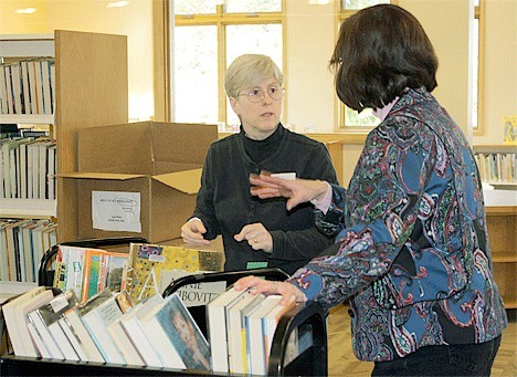 Coupeville Public Library employee Rabbitt Boyer talks with coworker Lorie King while restocking the books at the expanded library on Alexander Street. The newly renovated library is slated to open in mid-March with the grand opening in April.