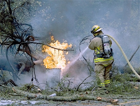 Ryan Nowicki of North Whidbey Fire and Rescue extinguishes a power transformer with foam Monday morning on West Beach Road.