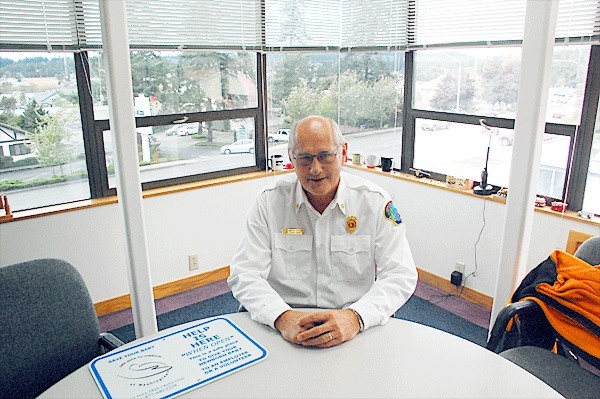 North Whidbey Fire and Rescue Chief Marv Koorn sits at a conference table in his third-story office at the district’s new administrative headquarters in Oak Harbor. Koorn is proposing several new capital and equipment purchases in the 2012 draft budget.
