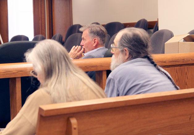 Bruce Montgomery listens to attorneys in Skagit County Superior Court. In the foreground are Marianne Edain and Steve Erickson