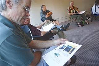 Pottery artist Dan Ishler reviews the proposed window sign for Oak Harbor’s new Garry Oak Gallery. The artist committee met at the store to discuss bylaws