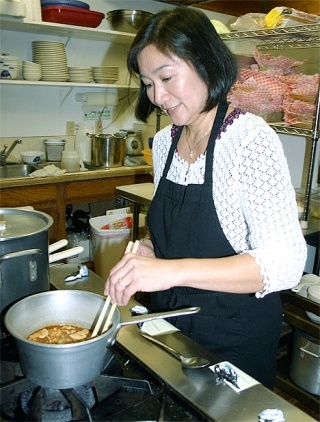 Kim's Cafe owner Kim Sittner prepares a meal at her new restaurant.