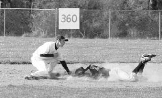 Monroe’s Ian Parmley eats a face full of dirt as he is tagged out by Oak Harbor second baseman Kurtis Weaver.