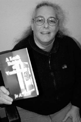 Oak Harbor author Jo Lord displays her first book.