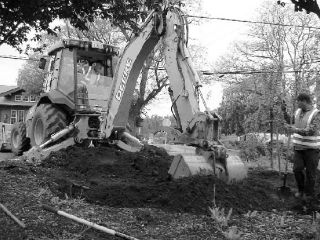 Ryan Neighbors and Matt Oberg of Island County Public Works perform the site prep and excavation for a rain garden Tuesday