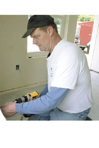 Electrician John Nichols of Oak Harbor’s AA Electric works on Habitat for Humanity’s new home in Northgate Terrace last week. A grand opening for the expedited project will be held June 7 at 4341 Hunter Lane.